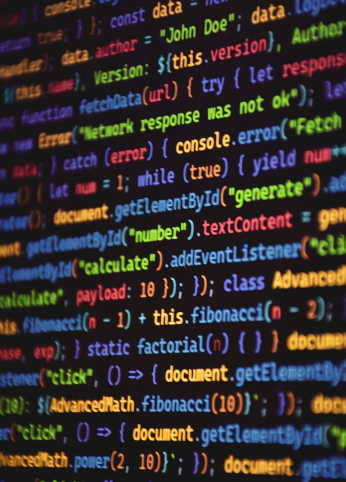 Close-up of vibrant colored JavaScript code showing functions and syntax on a dark screen.
